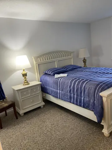 a bed room with a bed and a dresser