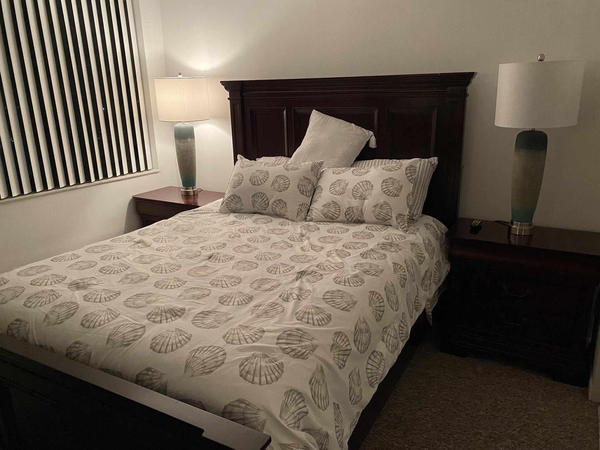 755 Dotterel Road, Unit 1108 Delray Beach, FL 33444 - Photo 16 of 28 a large bed sitting in a bedroom next to a lamp