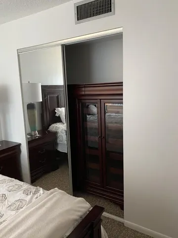 a bedroom with a bed and a dresser