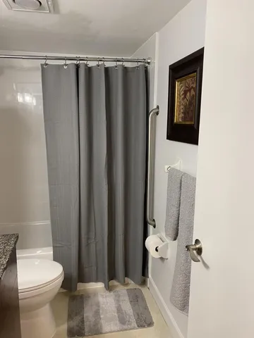 a bathroom with a shower curtain and a sink