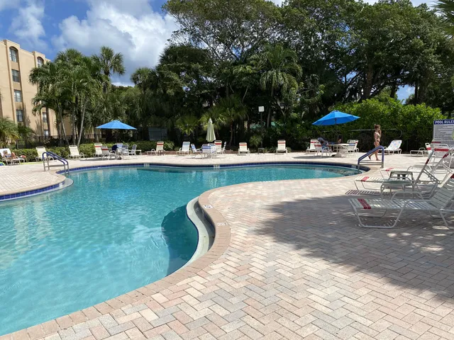 a view of a swimming pool with lounge chairs