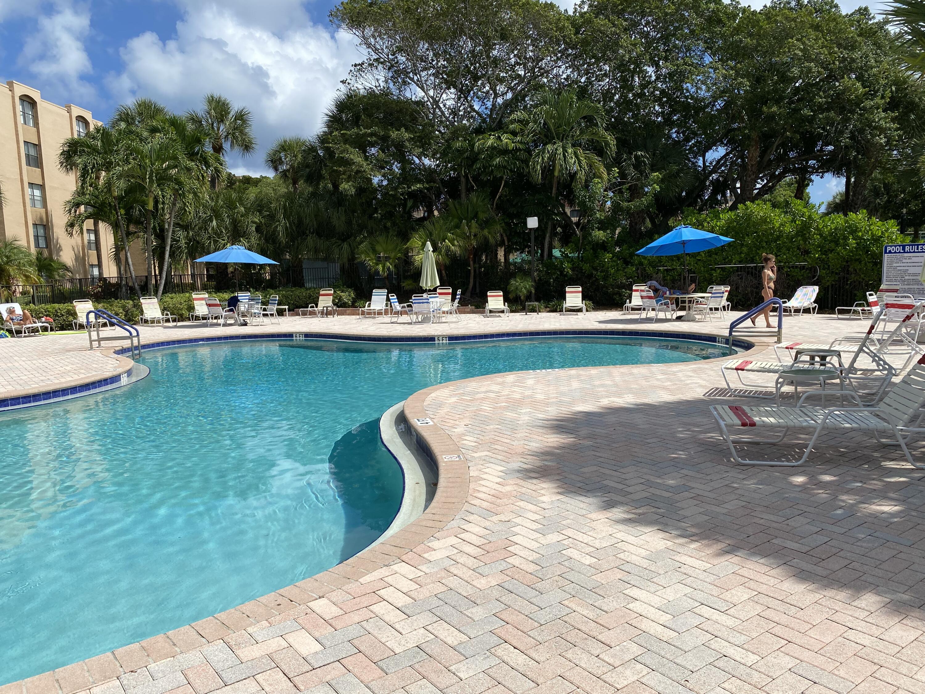755 Dotterel Road, Unit 1108 Delray Beach, FL 33444 - Photo 25 of 28 a view of a swimming pool with lounge chairs