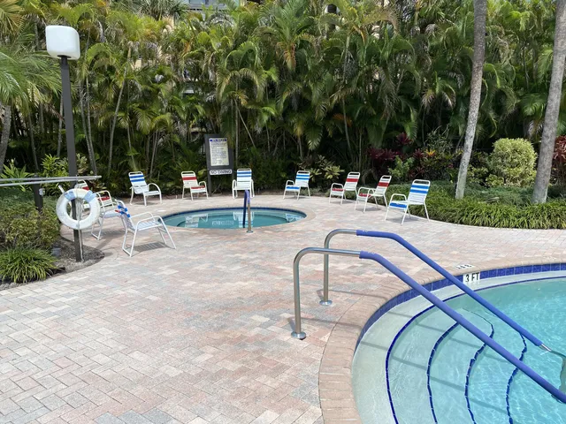 a swimming pool with outdoor seating and yard