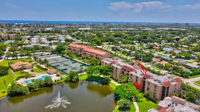 an aerial view of residential houses with outdoor space and lake view
