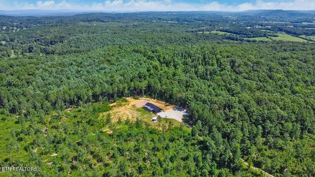 a aerial view of a house with a yard and outdoor seating