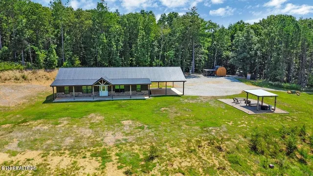 a view of a house with a yard patio and swimming pool
