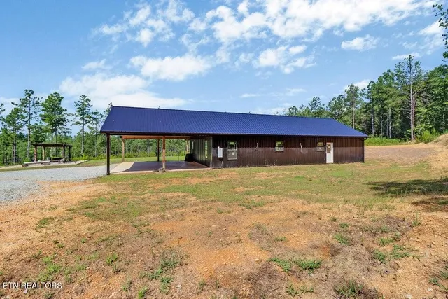 a view of house with backyard and a garden