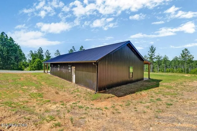 a view of backyard of house with green space