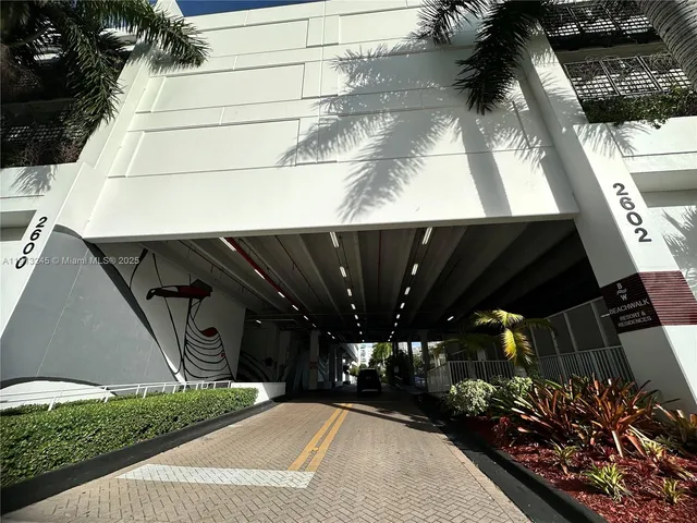 a lobby with furniture and floor to ceiling window