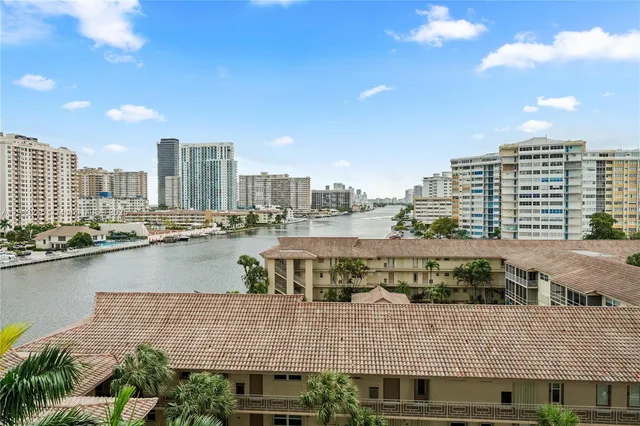 a bedroom with a bed and a lamp on dresser
