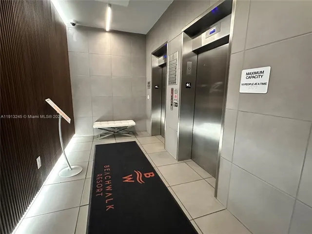 a large kitchen with stainless steel appliances a refrigerator and a stove top oven