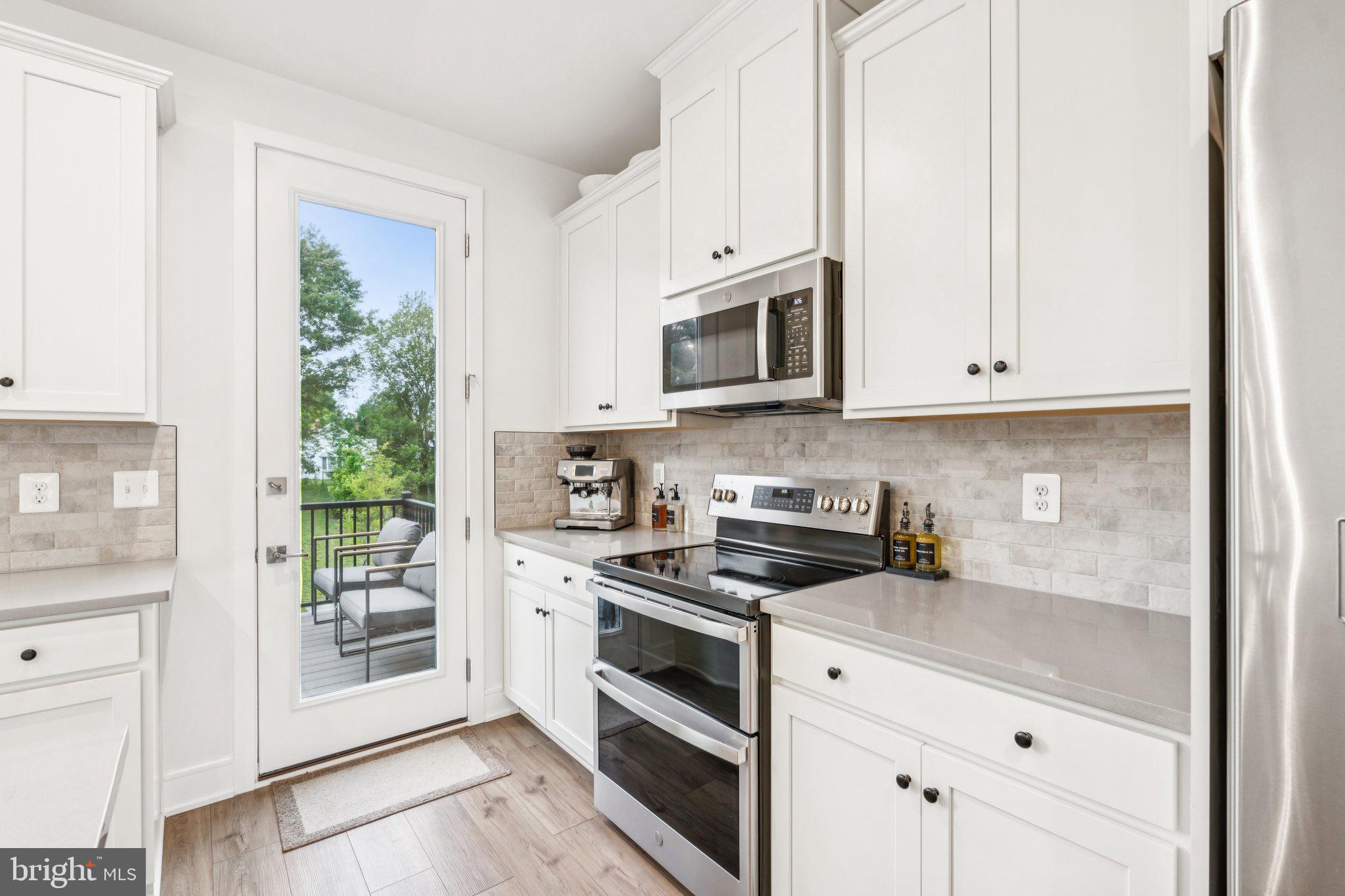 3580 Stephensons Hl Lane Marshall, VA 20115 - Photo 13 of 41 a kitchen with stainless steel appliances granite countertop white cabinets and a stove top oven