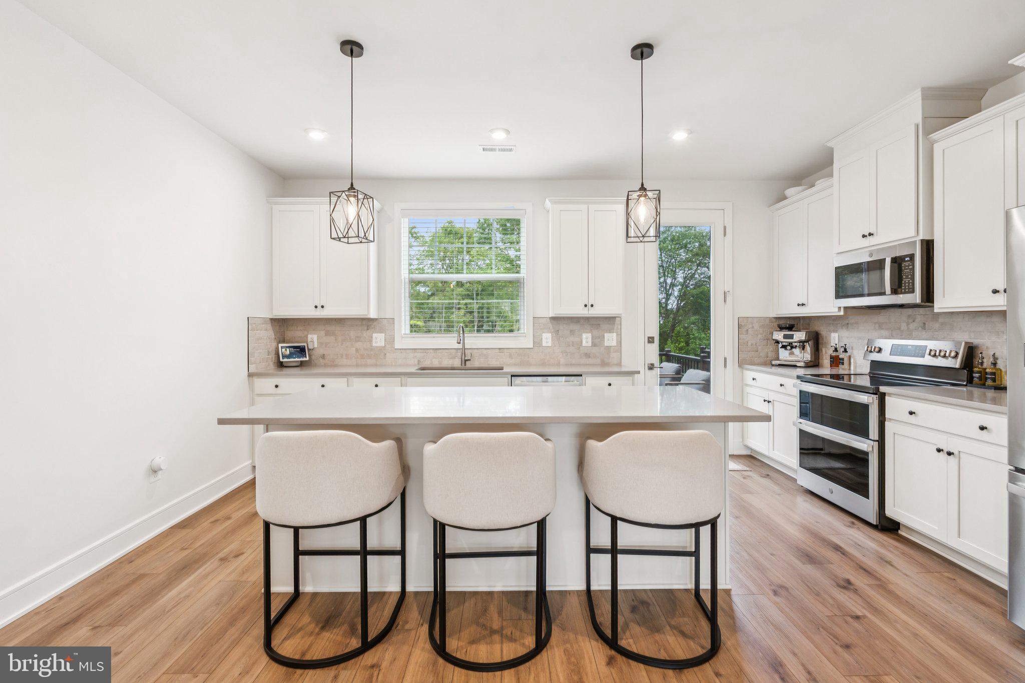 3580 Stephensons Hl Lane Marshall, VA 20115 - Photo 9 of 41 a kitchen with stainless steel appliances granite countertop a stove a sink and white cabinets with wooden floor