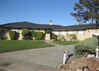 1240 Lasuen Drive Millbrae, CA 94030 - Photo 2 of 12 a front view of a house with a yard and garage