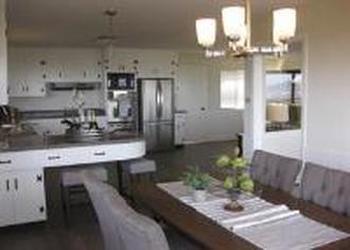 1240 Lasuen Drive Millbrae, CA 94030 - Photo 7 of 12 a kitchen with stainless steel appliances kitchen island granite countertop a table chairs in it and wooden floors