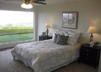 1240 Lasuen Drive Millbrae, CA 94030 - Photo 9 of 12 a bedroom with a bed and a chandelier