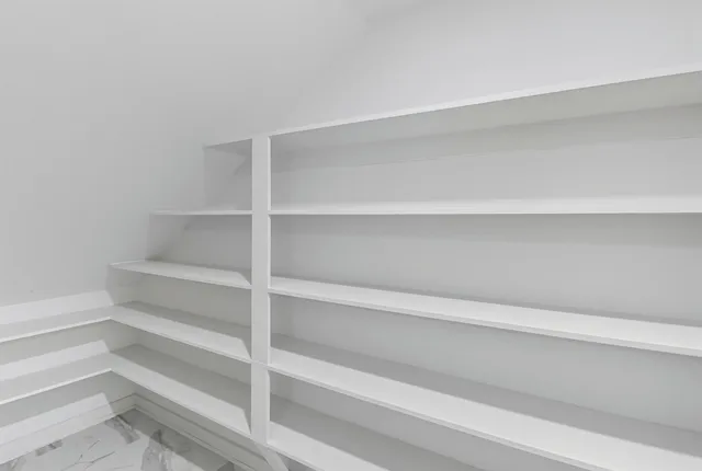 a kitchen with granite countertop white cabinets and a sink