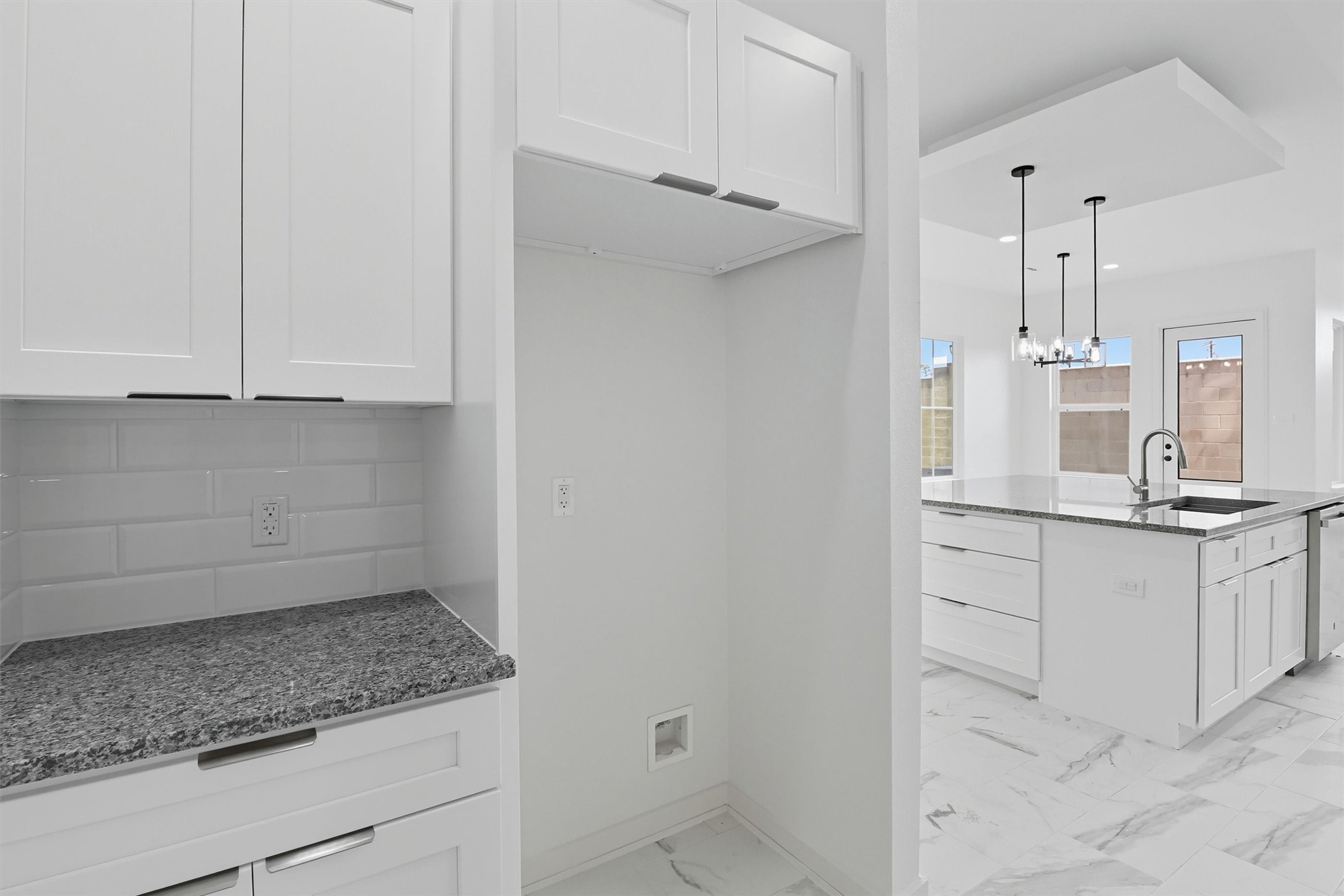 2927 El Fenice Lane Houston, TX 77057 - Photo 14 of 47 a kitchen with granite countertop white cabinets and a sink