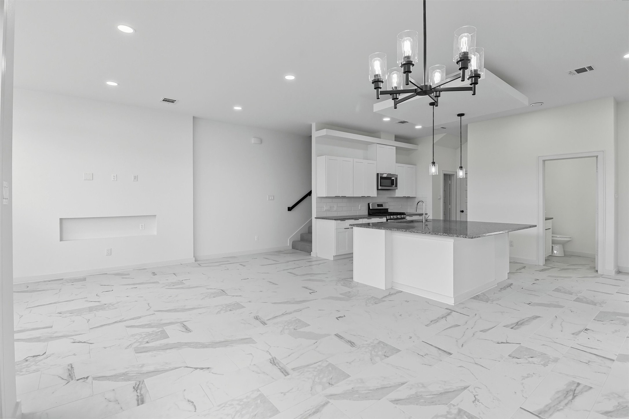 2927 El Fenice Lane Houston, TX 77057 - Photo 17 of 47 a view of kitchen with refrigerator stove and microwave