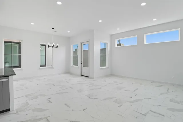 a large white kitchen with a large window