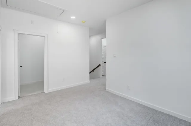 an empty room with closet and windows