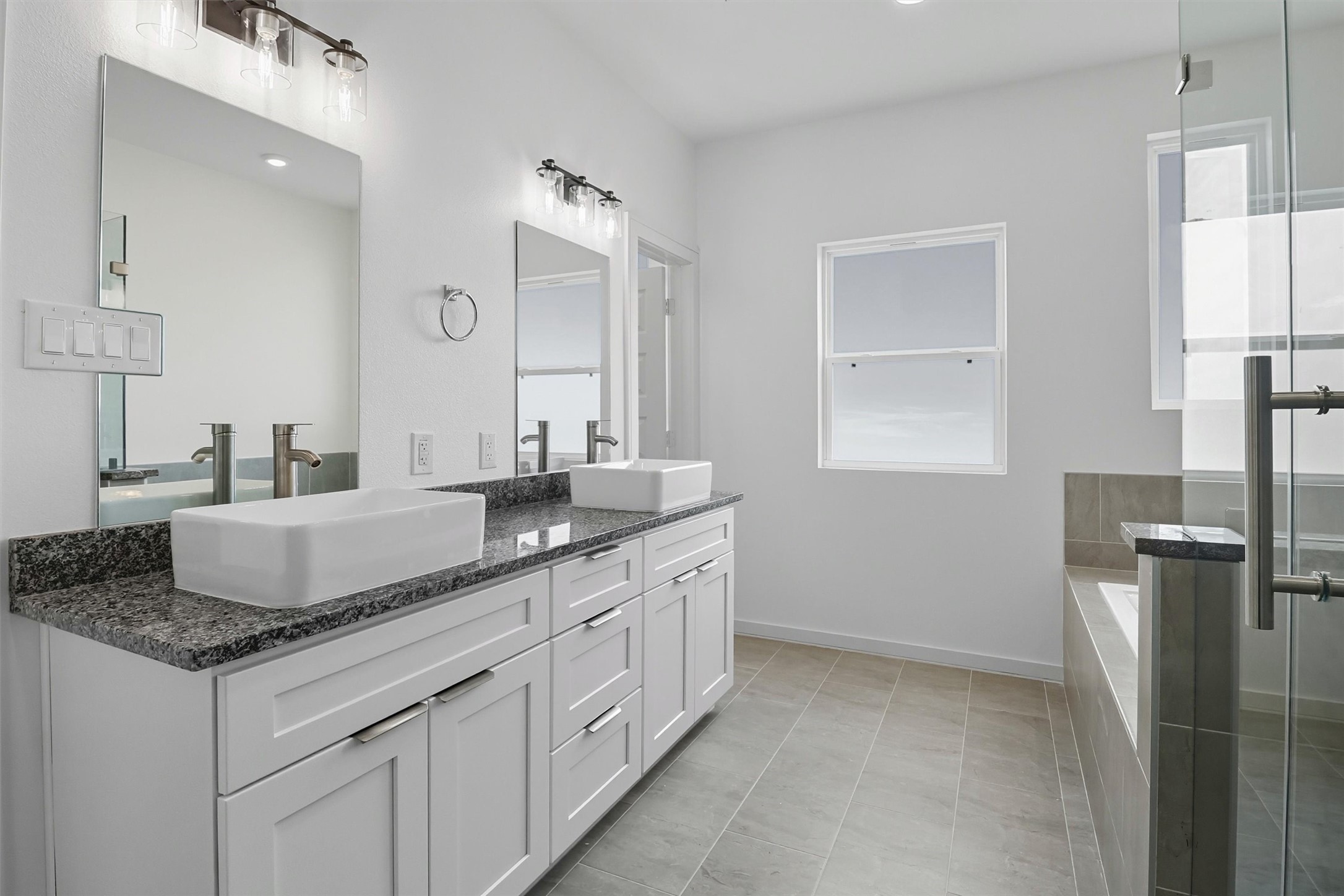 2927 El Fenice Lane Houston, TX 77057 - Photo 34 of 47 a bathroom with granite countertop a sink a toilet and a mirror