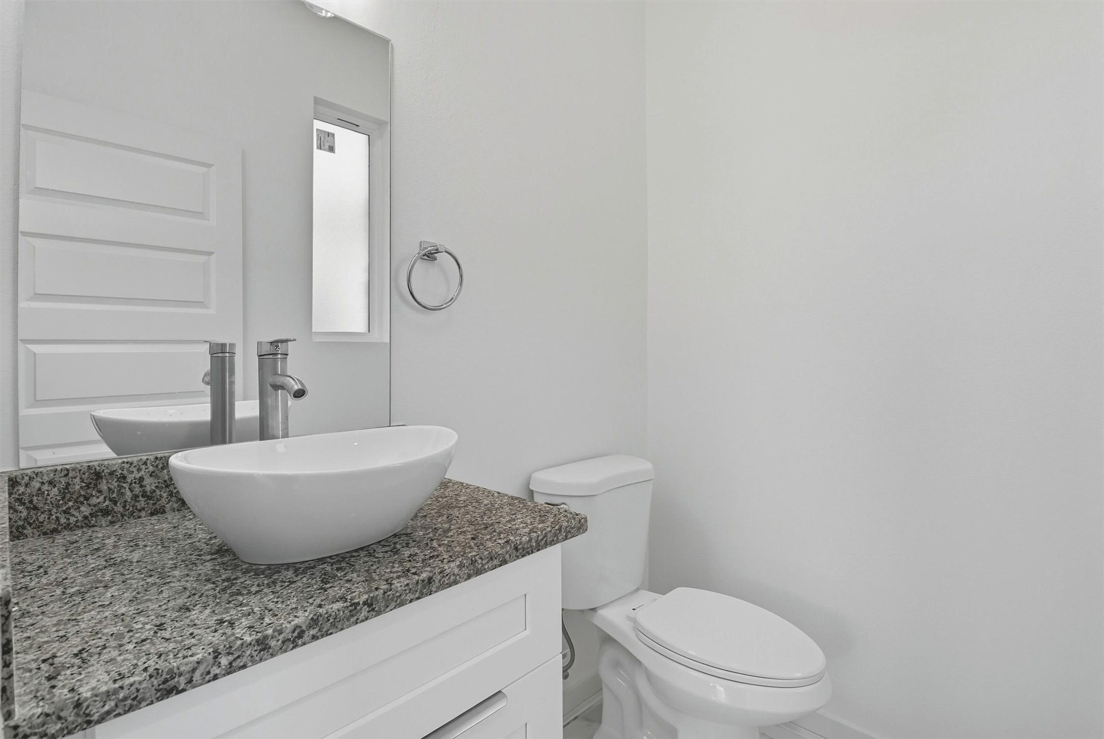 2927 El Fenice Lane Houston, TX 77057 - Photo 7 of 47 a bathroom with a granite countertop toilet a sink and a mirror
