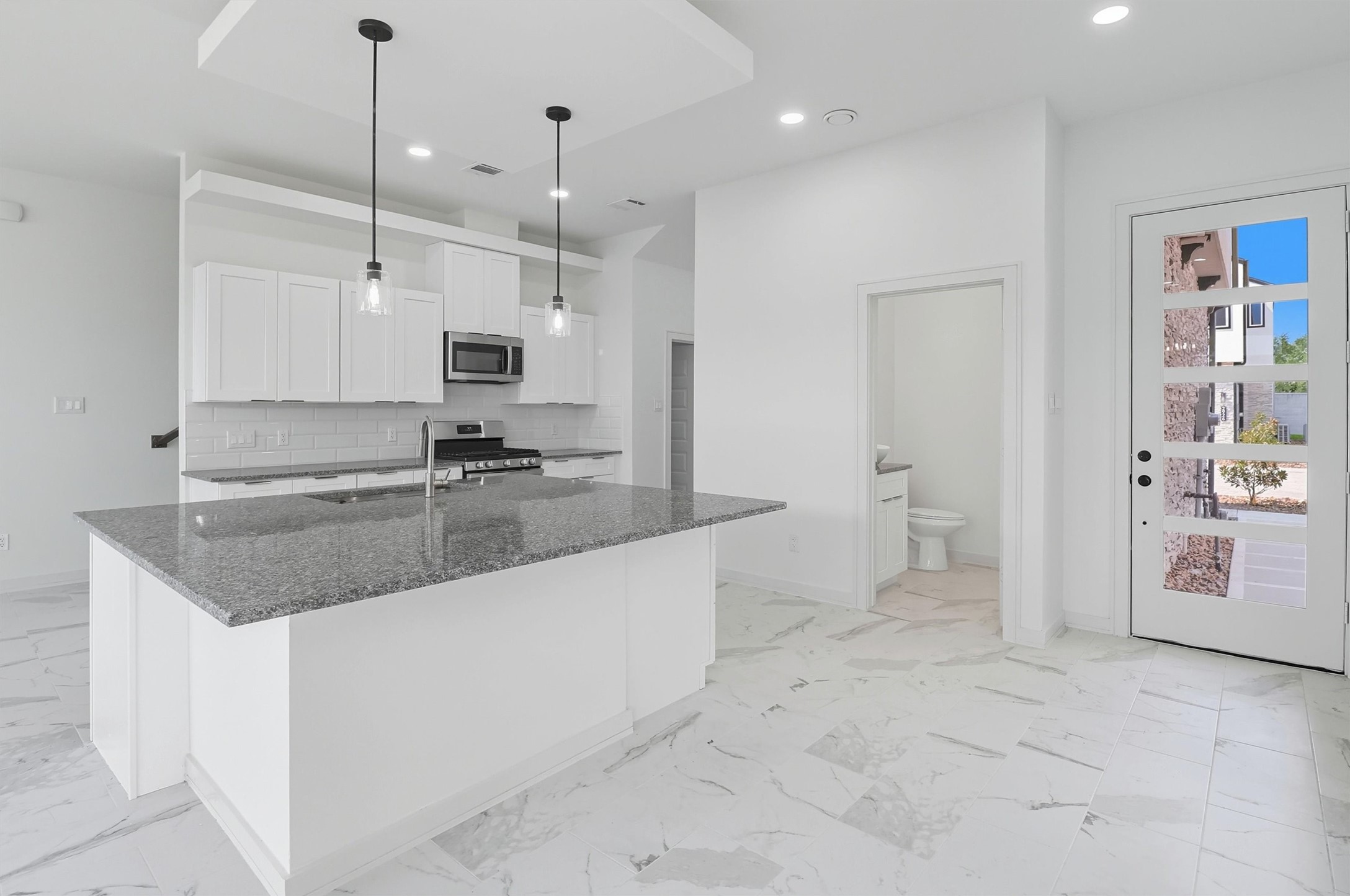 2927 El Fenice Lane Houston, TX 77057 - Photo 9 of 47 a large kitchen with granite countertop a sink and a stove top oven