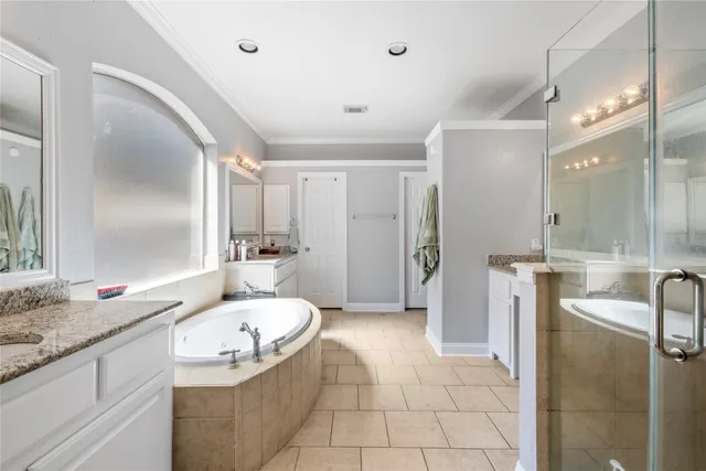 a bathroom with a granite countertop tub sink and mirror