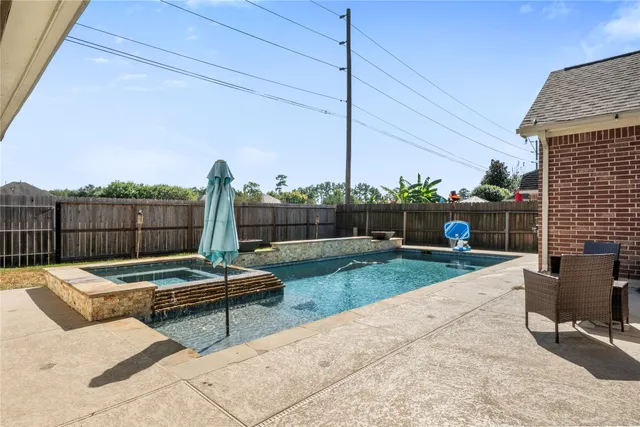 a view of a patio with a table and chairs