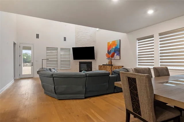 a living room with furniture a flat screen tv and a fireplace