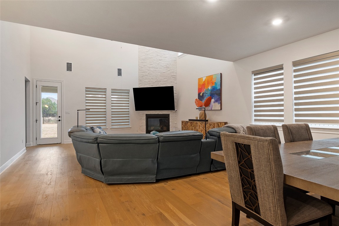 682 Two Creeks Lane Austin, TX 78737 - Photo 11 of 33 a living room with furniture a flat screen tv and a fireplace