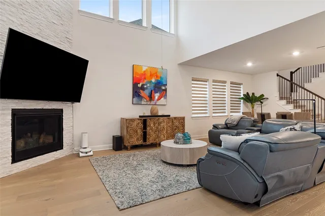 a living room with furniture a flat screen tv and a fireplace