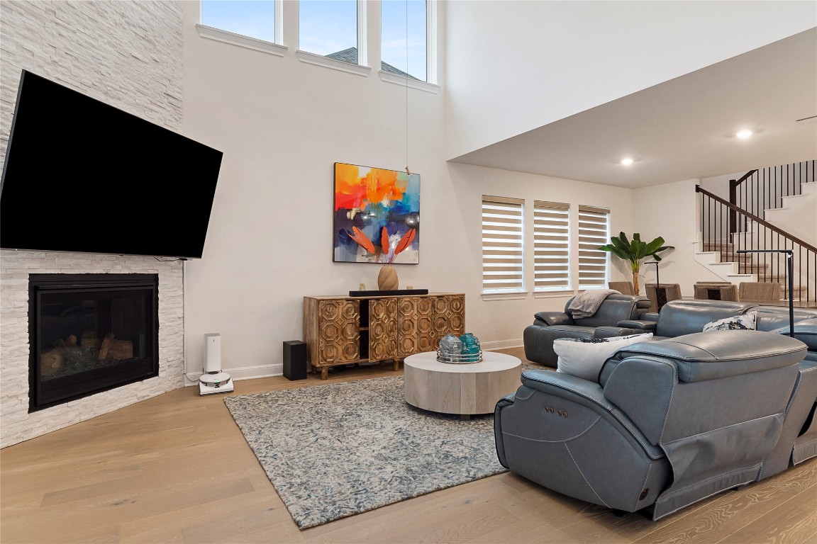 682 Two Creeks Lane Austin, TX 78737 - Photo 12 of 33 a living room with furniture a flat screen tv and a fireplace