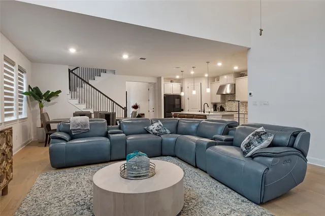 a living room with furniture and a dining table