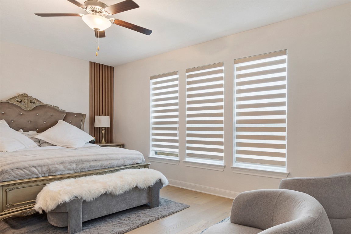 682 Two Creeks Lane Austin, TX 78737 - Photo 15 of 33 a bedroom with a bed and a window