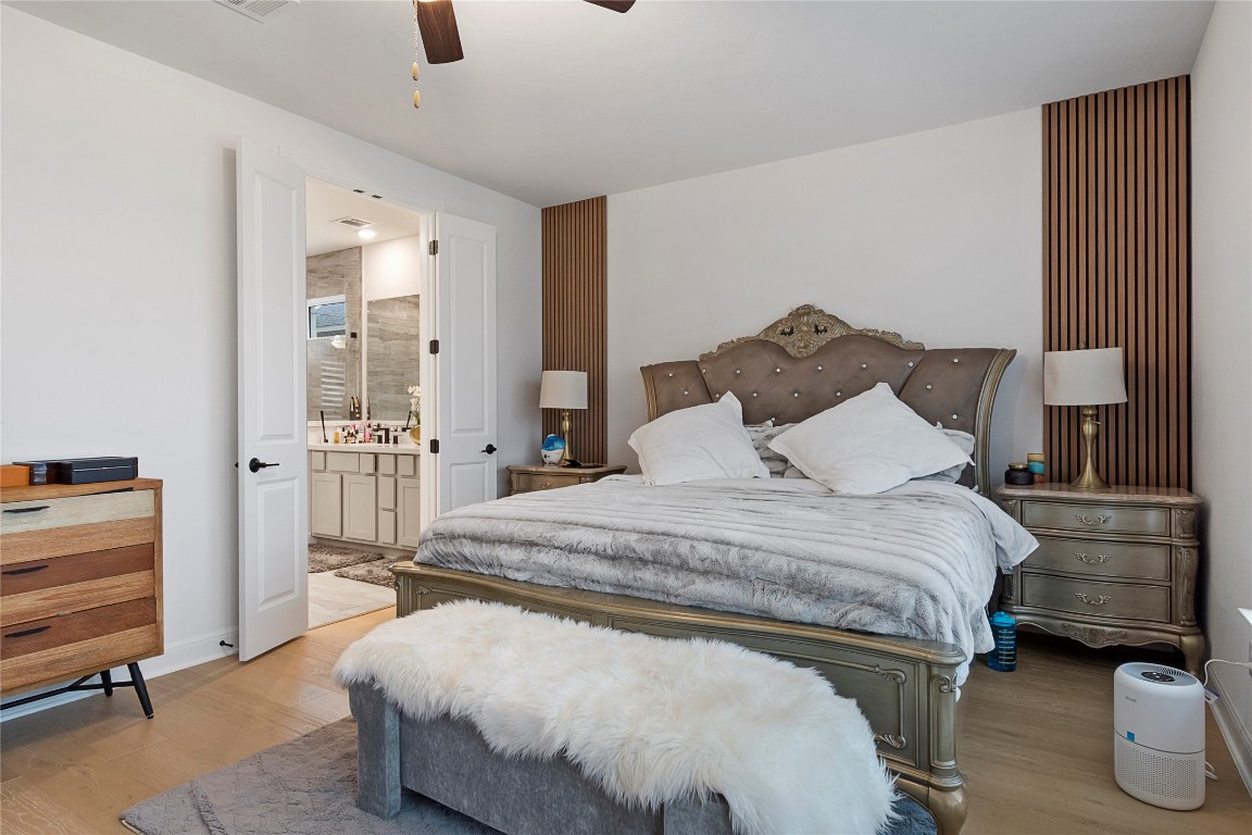 682 Two Creeks Lane Austin, TX 78737 - Photo 16 of 33 a spacious bedroom with a bed and furniture