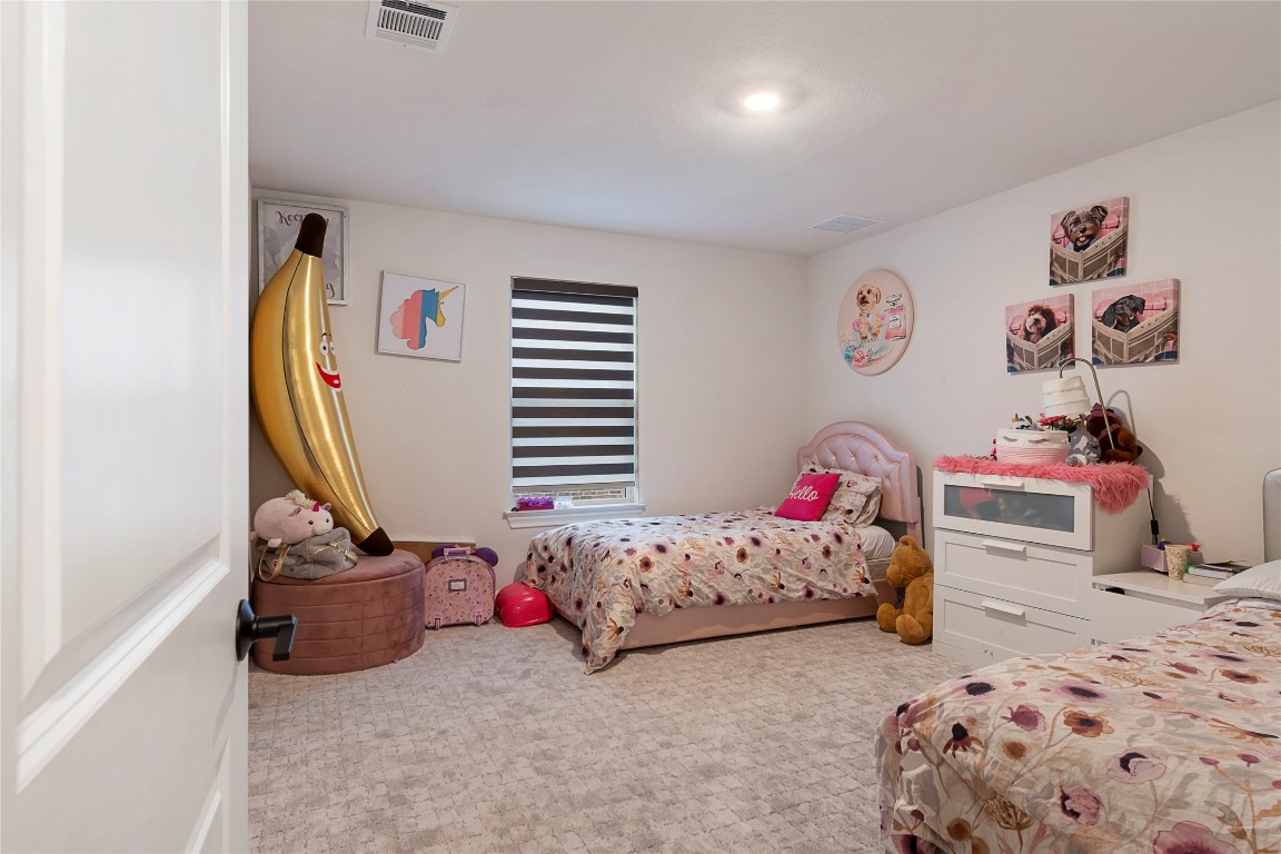 682 Two Creeks Lane Austin, TX 78737 - Photo 21 of 33 a bedroom with a bed and a window