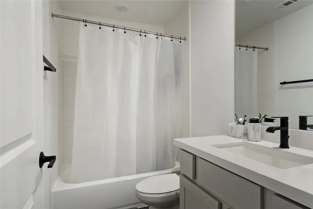 a bathroom with a sink a toilet and a bathtub