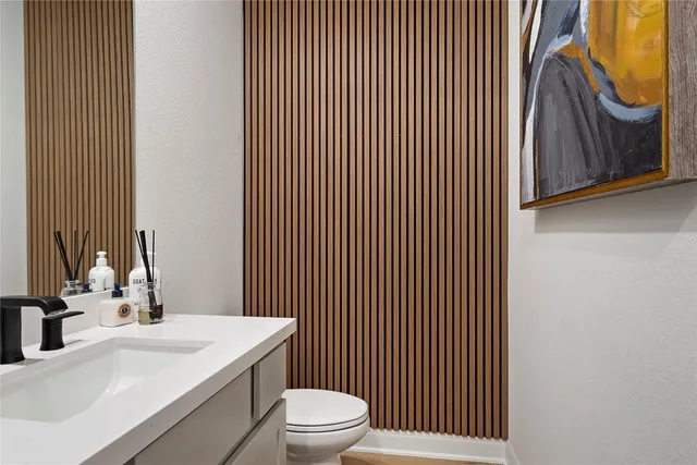a bathroom with a sink a toilet and mirror