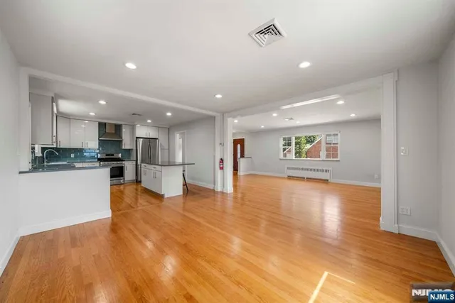 a view of kitchen with kitchen island and stainless steel appliances