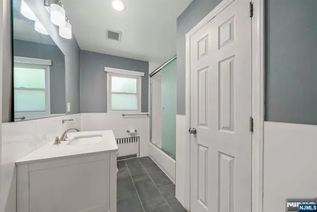 a bathroom with a sink a mirror and a toilet