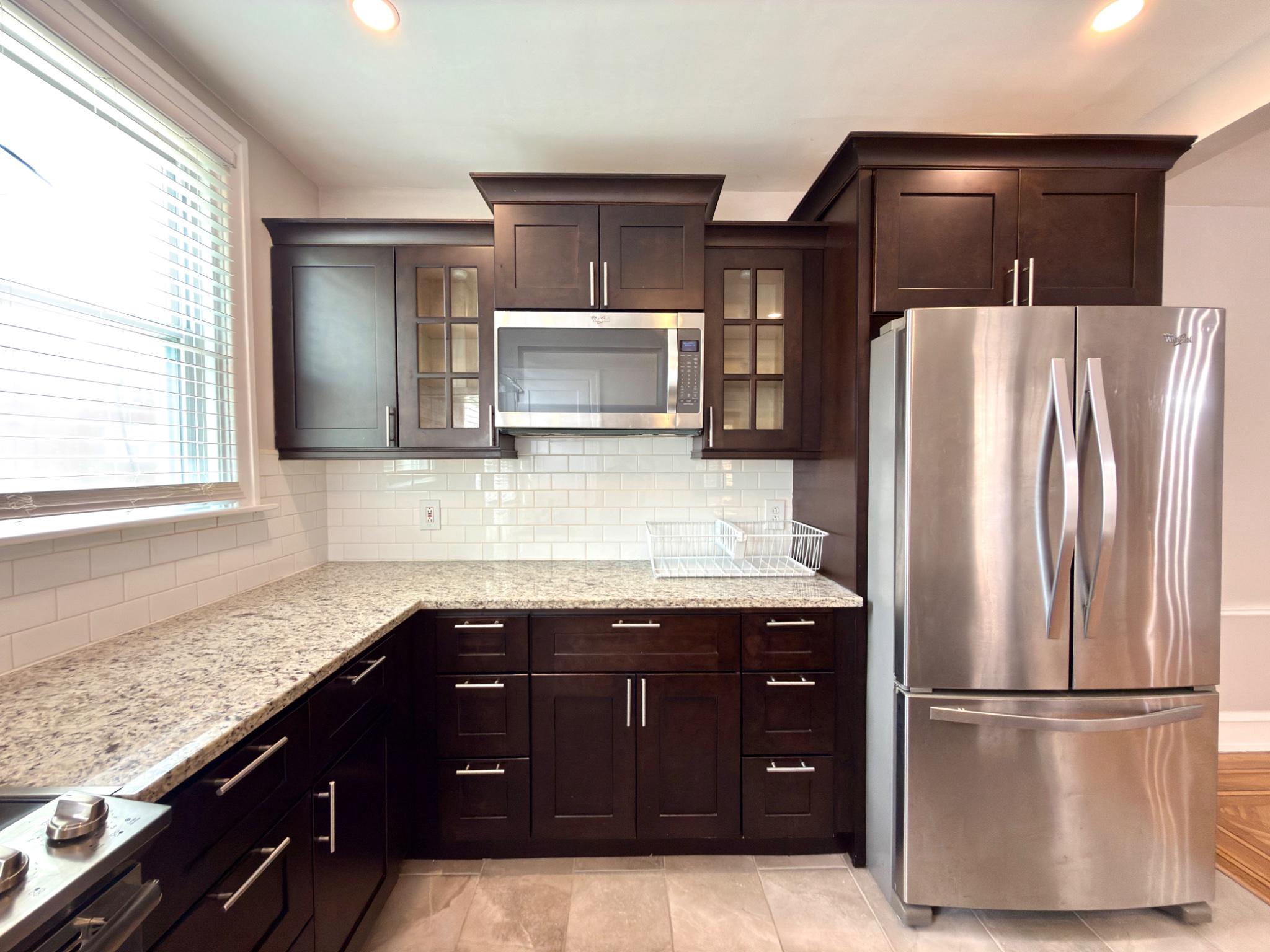 1723 Chelsea Road Elkins Park, PA 19027 - Photo 15 of 38 a kitchen with granite countertop a refrigerator and a sink