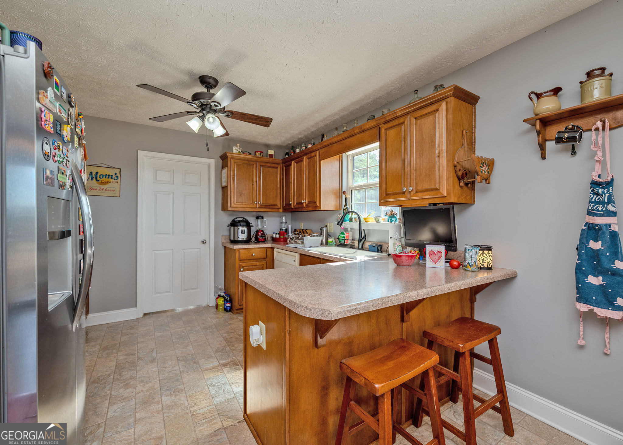 1363 McFarlin Bridge Road Carnesville, GA 30521 - Photo 12 of 78 a kitchen with stainless steel appliances granite countertop a sink a stove and a refrigerator