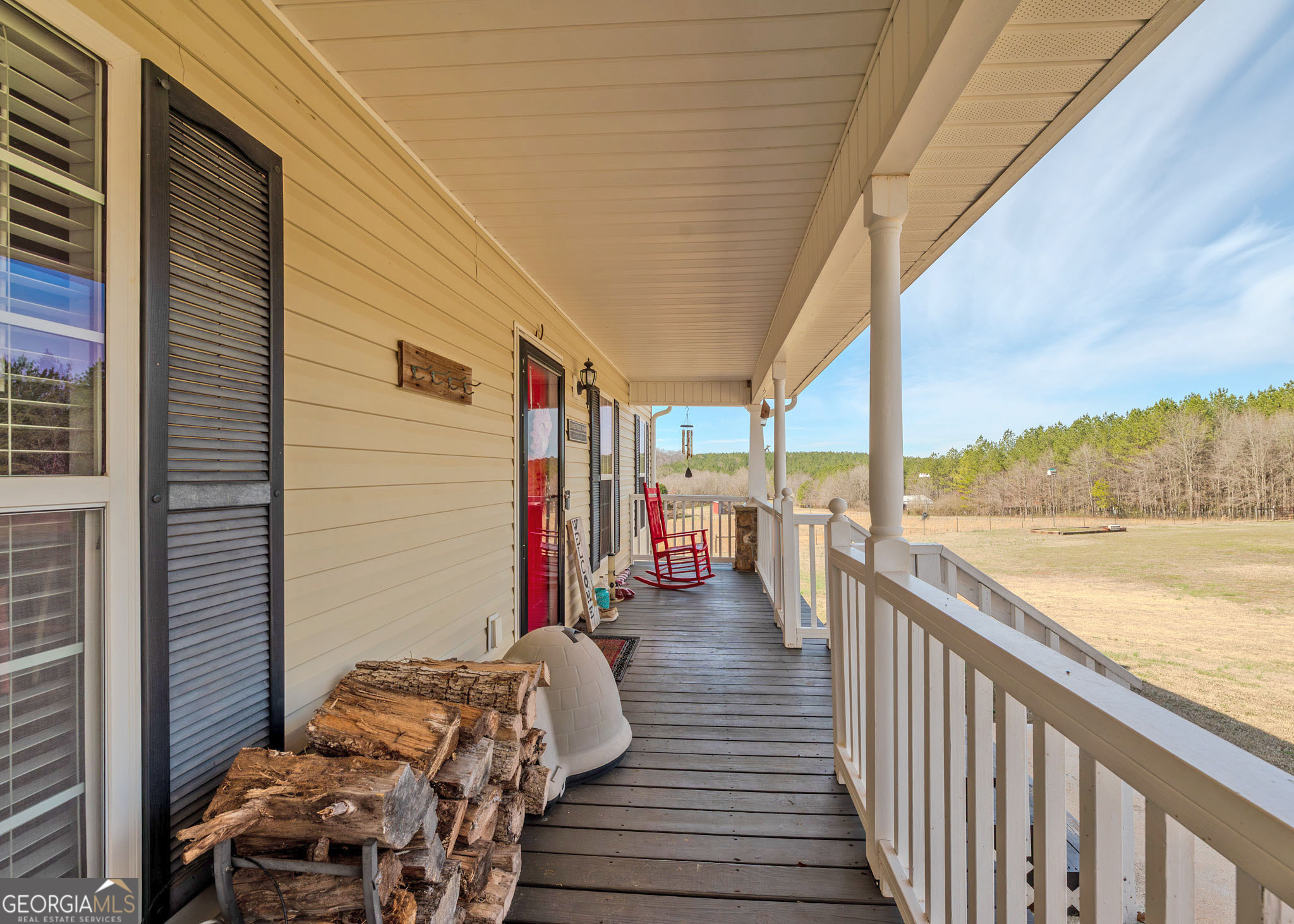 1363 McFarlin Bridge Road Carnesville, GA 30521 - Photo 6 of 78 a view of a balcony with chair and wooden floor