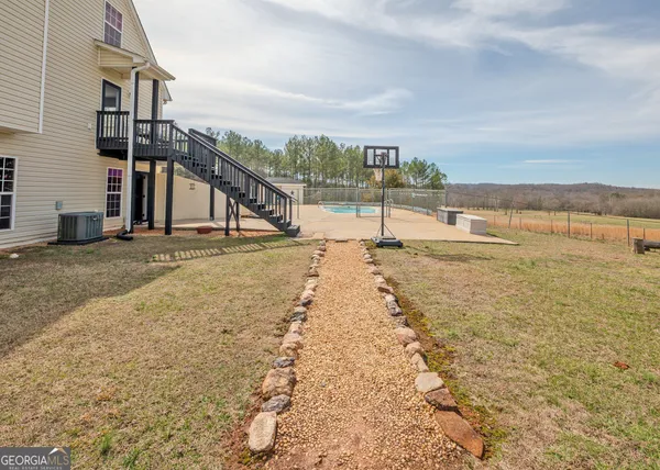 a kitchen with stainless steel appliances granite countertop a refrigerator a stove top oven a sink and dishwasher