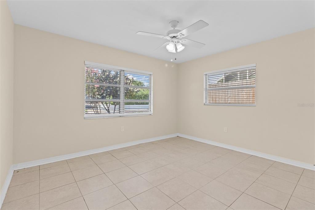 512 Richmond Street Dunedin, FL 34698 - Photo 18 of 37 an empty room with windows and fan