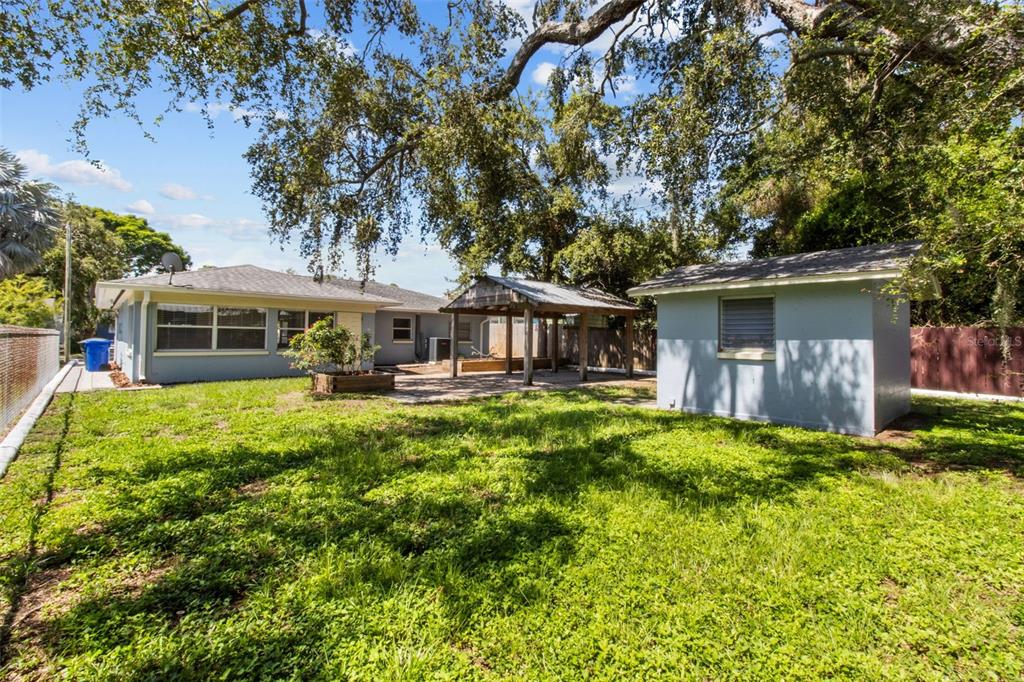 512 Richmond Street Dunedin, FL 34698 - Photo 24 of 37 a front view of a house with a yard table and chairs