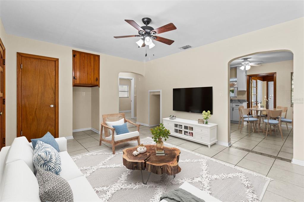 512 Richmond Street Dunedin, FL 34698 - Photo 3 of 37 a living room with furniture and a flat screen tv