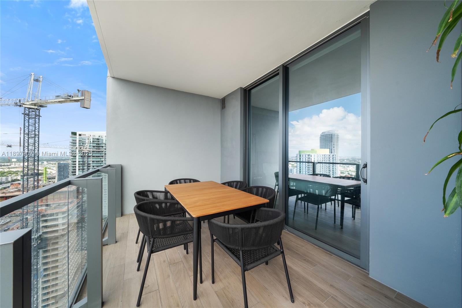 88 Southwest 7th Street, Unit 3910 Miami, FL 33130 - Photo 15 of 38 a view of a dining room with furniture and wooden floor